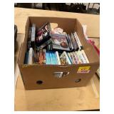 Box of DVDs and Wii games