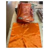 Bag of orange satin place mats 17x17in
