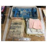 Glass table service, linens, old newspaper