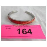 Inlaid red stone in silver bracelet