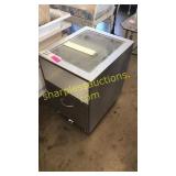 Glass top end table on wheels