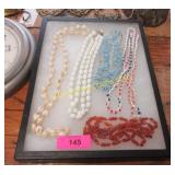 Display of vintage necklaces