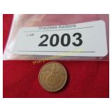 1938 German coin with swastika .