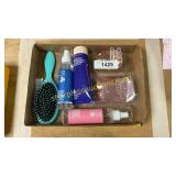 Box of body lotion, spray, glitter, hair brush