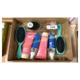 Box of body lotion, spray, hairbrushes