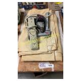 White tarp, surge protector, drill, caulk gun