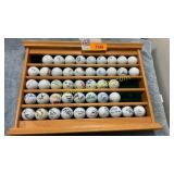 Autographed gold balls in rack