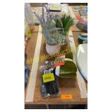 Plastic silverware, fake plants, jar, pillow sham