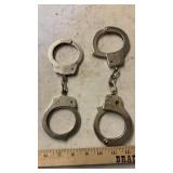 (2) HANDCUFFS, EARMUFFS, HKS SPEEDLOADER, &