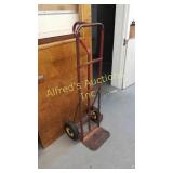 Steel hand truck, solid tires 52 in tall.