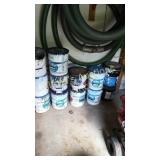 14 open cans of pool paint in different colors