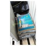 Three bags of pool filter sand.