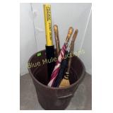 Trash can, walking stick, umbrellas