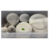 White dishes in storage tub