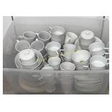 Tub full of white dishes