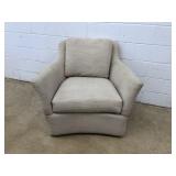 Upholstered Tan Swivel Armchair