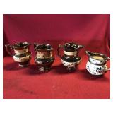 Four Copper Lustre Creamers