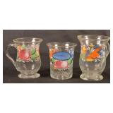 Three Enamel Decorated Blown Glass Mugs.