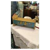 Metal cradle, ironing board, and washing machine