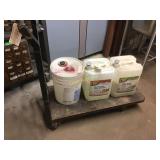 Small metal cart on wheels, cleaning supplies not
