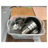 Bin of assorted stainless inserts in bowls