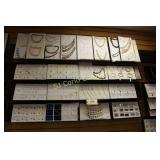 Display cards of assorted jewelry on wall