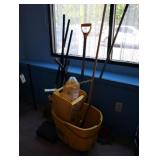 Assorted cleaning supplies, mops, brooms