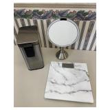 Bathroom items incl scale, trash can, & mirror