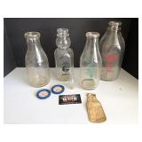 Various size milk bottles with advertising