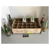 7-Up pop crate and various glass bottles and
