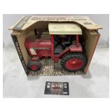 886 tractor with safety frame Ertl, dirty.