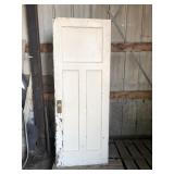 Three panel rustic wood door with brass knob
