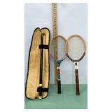 Pool stick and two tennis rackets