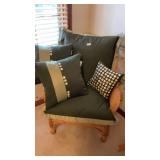 Wicker chair with green button pillows