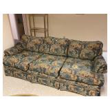 Floral sofa with paint stain
