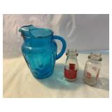 Blue glass pitcher with a small milk bottles
