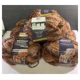 Eight Bernat toasty bulky 7.9 yard balls of yarn.