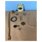 Lots of jewelry, necklaces, bracelet, pins and