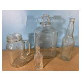 4 glass bottles, tallest is 11", smallest is 5"