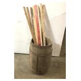 Antique nail bucket filled with vintage yardsticks
