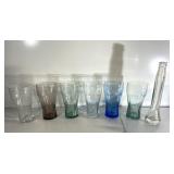 Six Coca-Cola glasses and a random glass