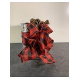 Metal coffee can filled with small pine ones