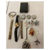Assortment of jewelry items, watches, pins,