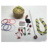 Basket w/ 1980s rubber bracelets, Rubik cube neck-