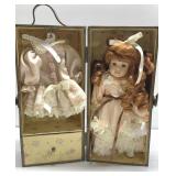 Porcelain doll with clothes in wood case Porcelain doll with clothes in wood case
