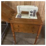 Vintage Sears Kenmore sewing machine in cabinet