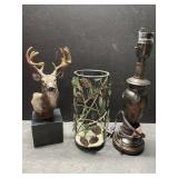 Deer bust on heavy slab of marble, pinecone,