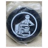 Hockey pucks with Trucker design on it
