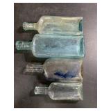 Four miscellaneous bottles. Tallest one is 8 1/2