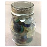 3-1/2' tall baby food jar full of buttons.